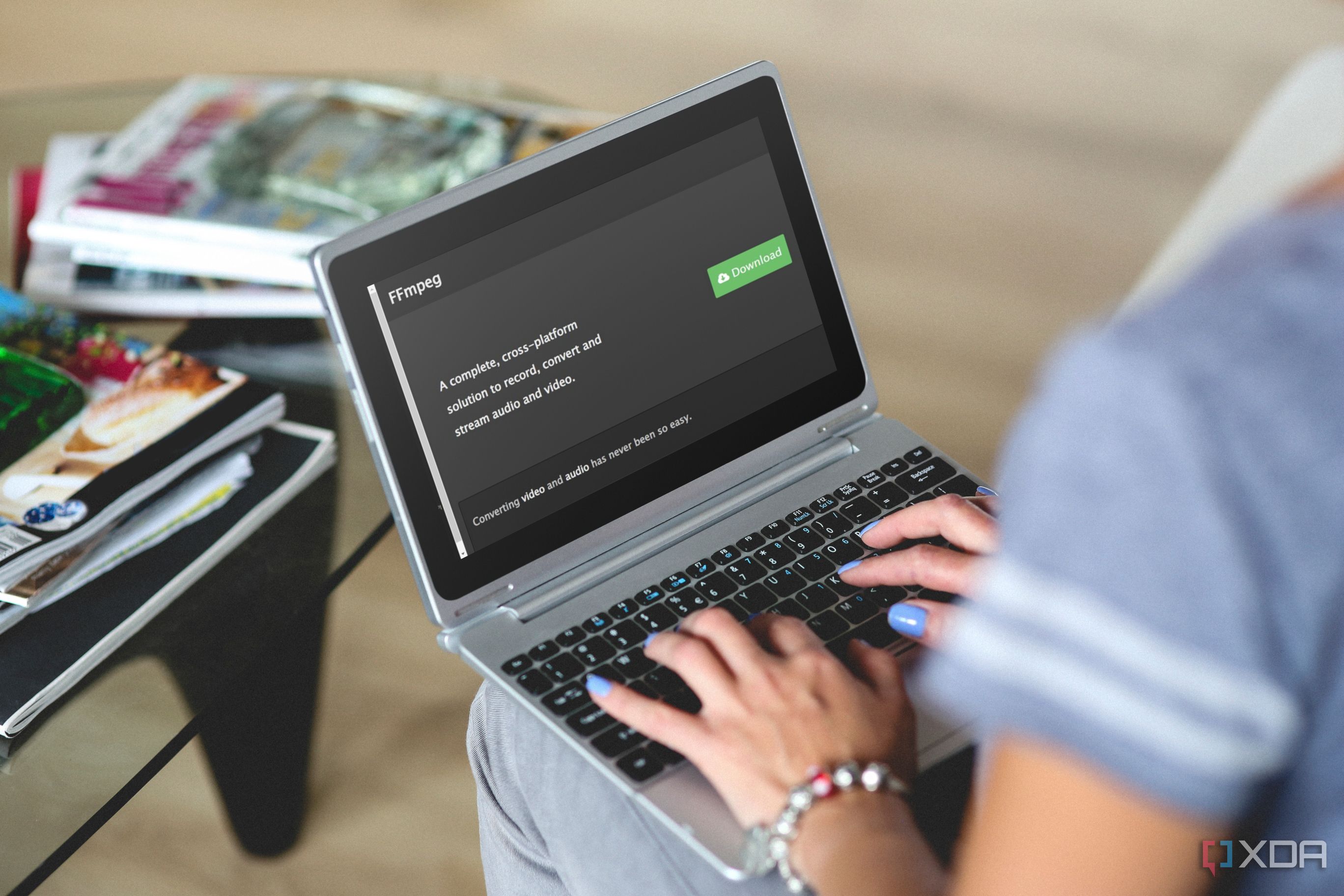 person using a laptop with FFmpeg download page on screen