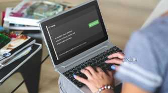 person using a laptop with FFmpeg download page on screen
