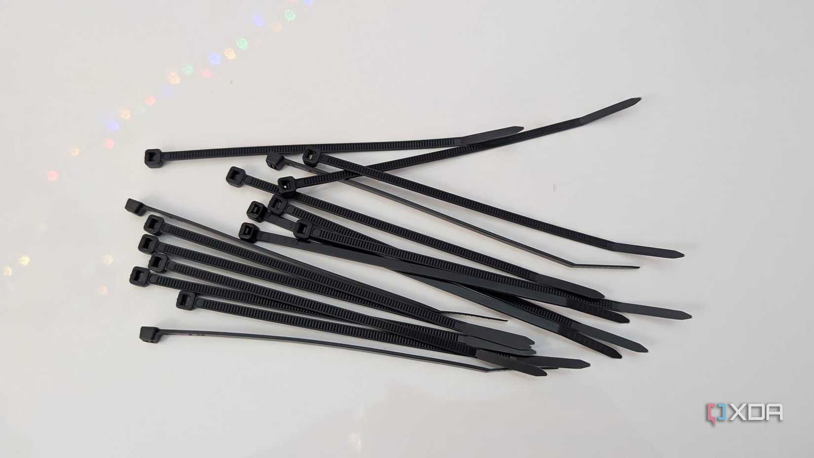 an image showing multiple black cable ties on a white background