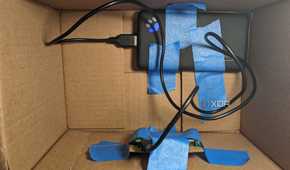 Raspberry Pi and power bank taped to inside of box
