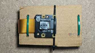 Raspberry Pi Camera Module 2 mounted on cardboard