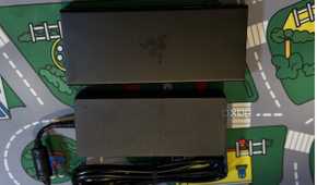 razer usb 4 dock seen from the top next to its power brick