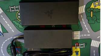 razer usb 4 dock seen from the top next to its power brick