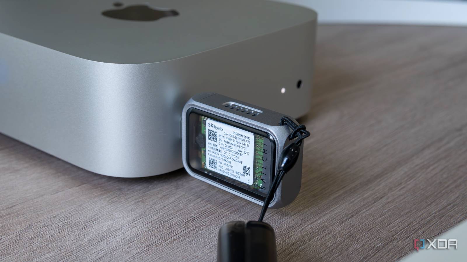 The Satechi Mini NVMe SSD Enclosure plugged into a port on the 2024 Mac Mini, showing the SSD inside
