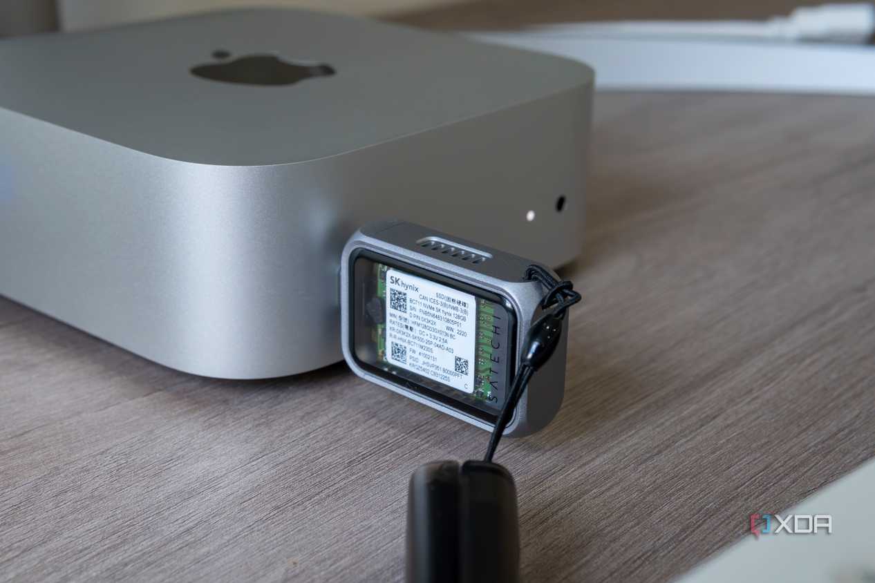 The Satechi Mini NVMe SSD Enclosure plugged into a port on the 2024 Mac Mini, showing the SSD inside