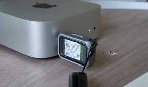 The Satechi Mini NVMe SSD Enclosure plugged into a port on the 2024 Mac Mini, showing the SSD inside