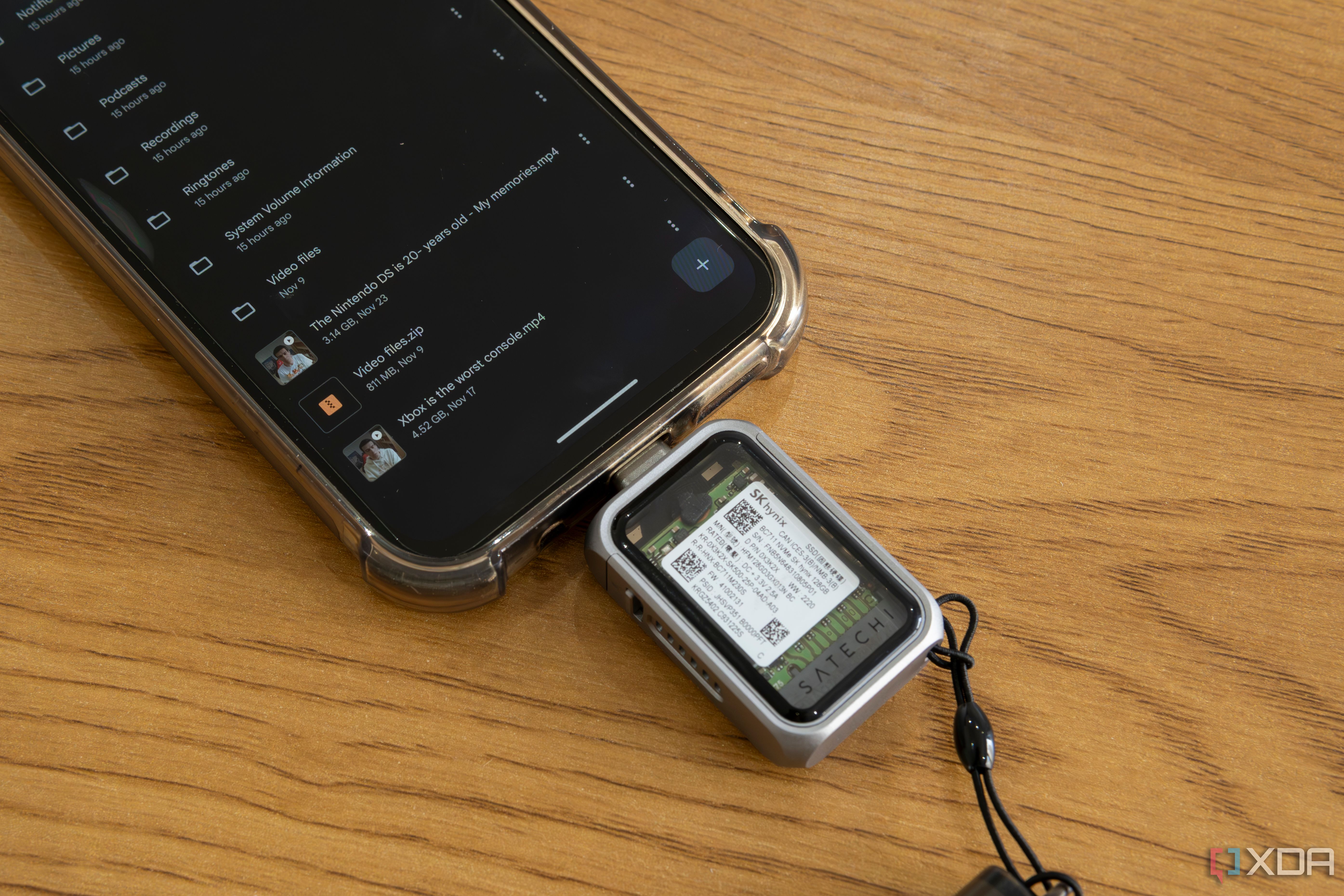 Close-up view of the Satechi Mini NVMe SSD Enclosure plugged into a phone