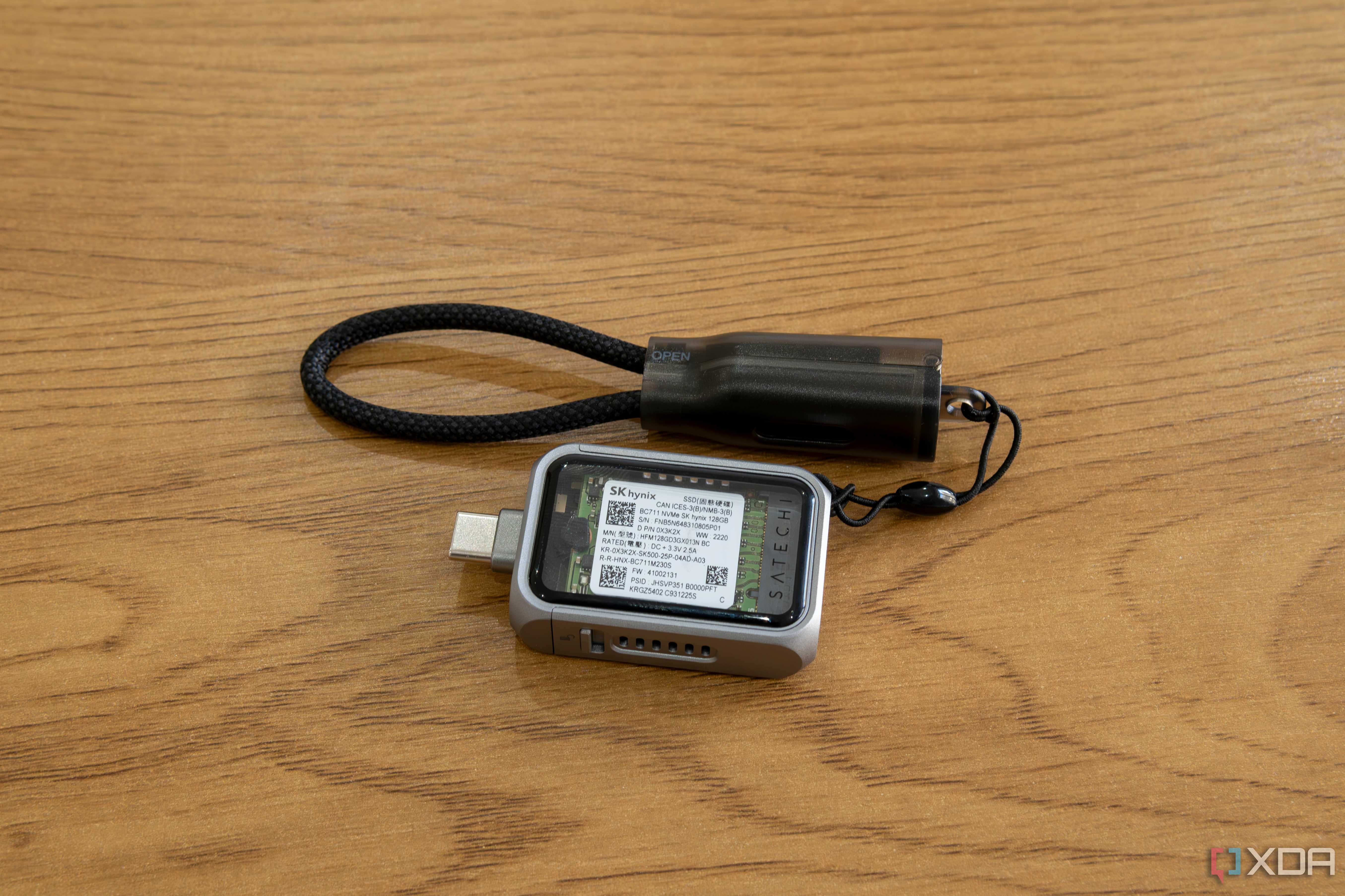 The Satechi Mini NVMe SSD Enclosure with the included USB-C cable lanyard