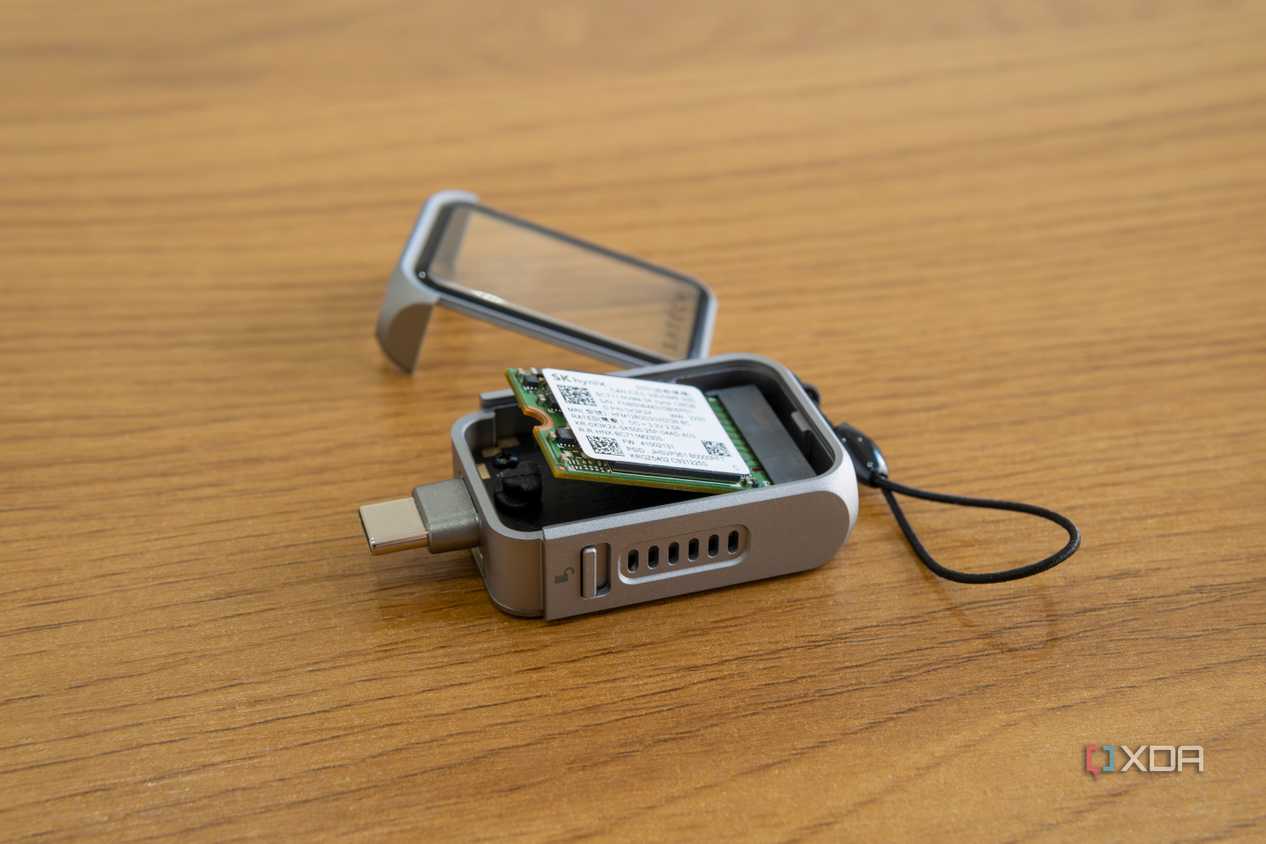 Angled view of the Satechi Mini NVMe SSD Enclosure with an SSD partly inserted