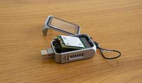 Angled view of the Satechi Mini NVMe SSD Enclosure with an SSD partly inserted