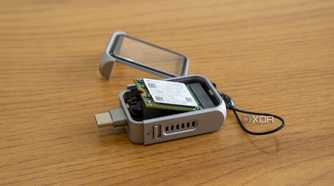 Angled view of the Satechi Mini NVMe SSD Enclosure with an SSD partly inserted