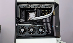 An image showing a completed PC build in a white case with the side panel off showing the components inside
