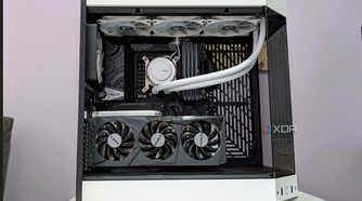 An image showing a completed PC build in a white case with the side panel off showing the components inside