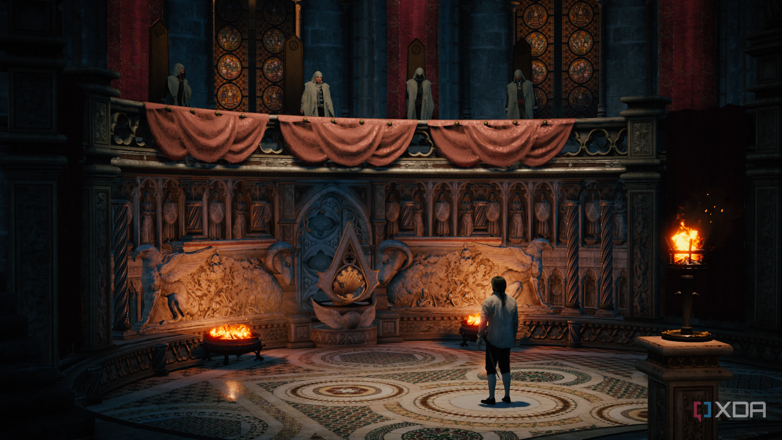 Arno looking up to four hooded figures in his initiation as an Assassin