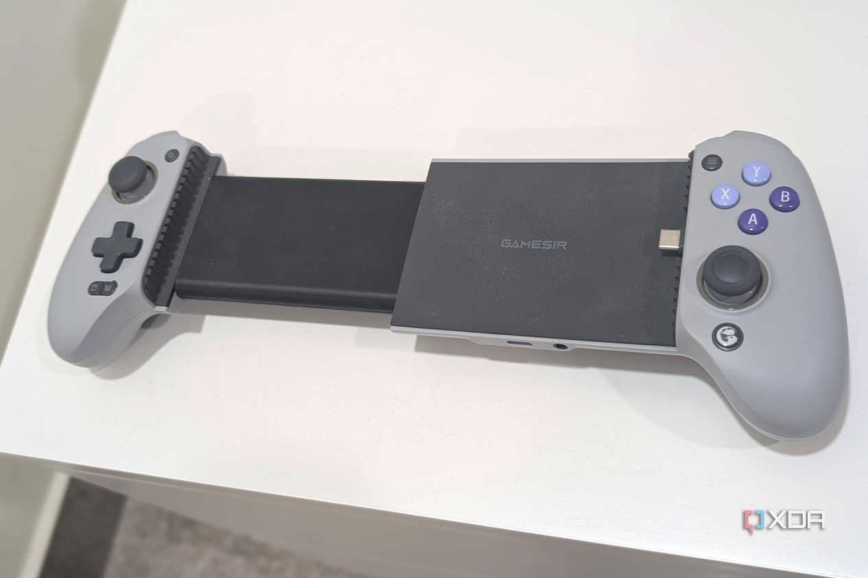 A grey Gamesir Galileo G8, extended, kept atop a white table.
