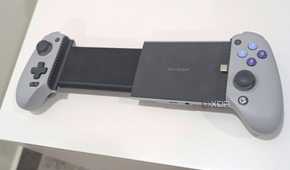 A grey Gamesir Galileo G8, extended, kept atop a white table.