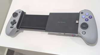 A grey Gamesir Galileo G8, extended, kept atop a white table.