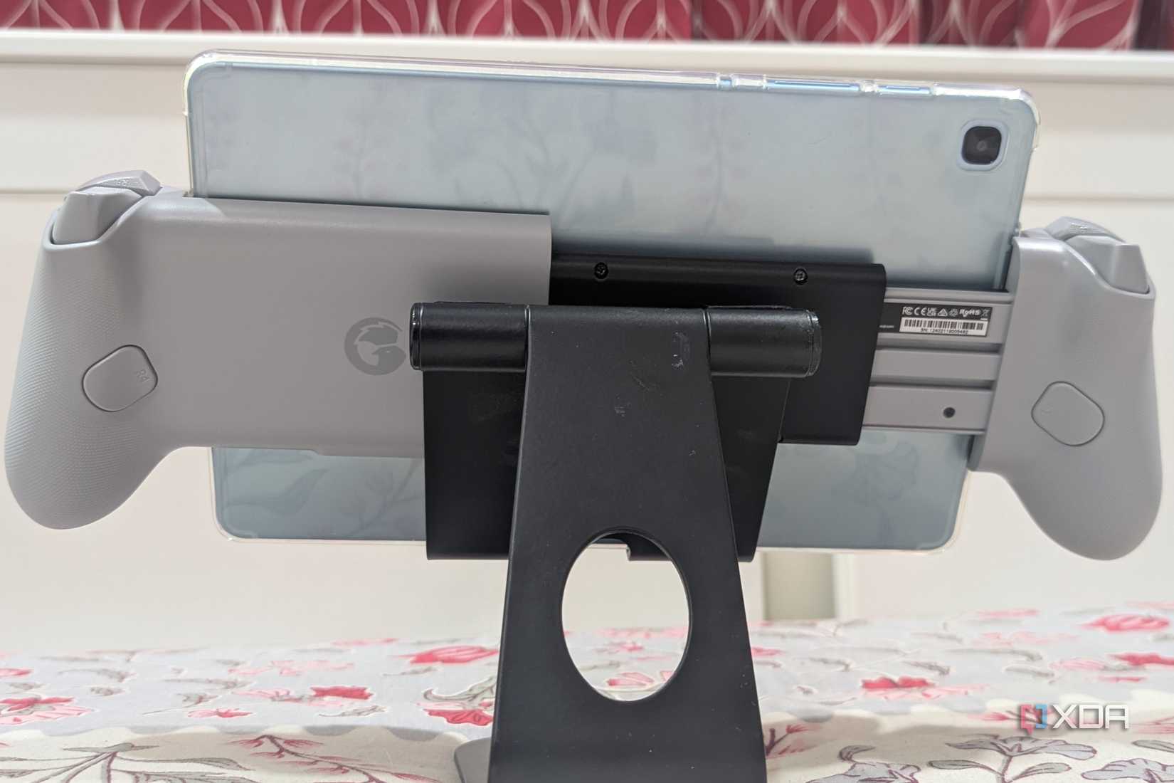An image of the Galileo G8 from Gamesir from the rear, being held up on a black phone stand, with a Samsung Galaxy Tab S6 Lite installed in it.