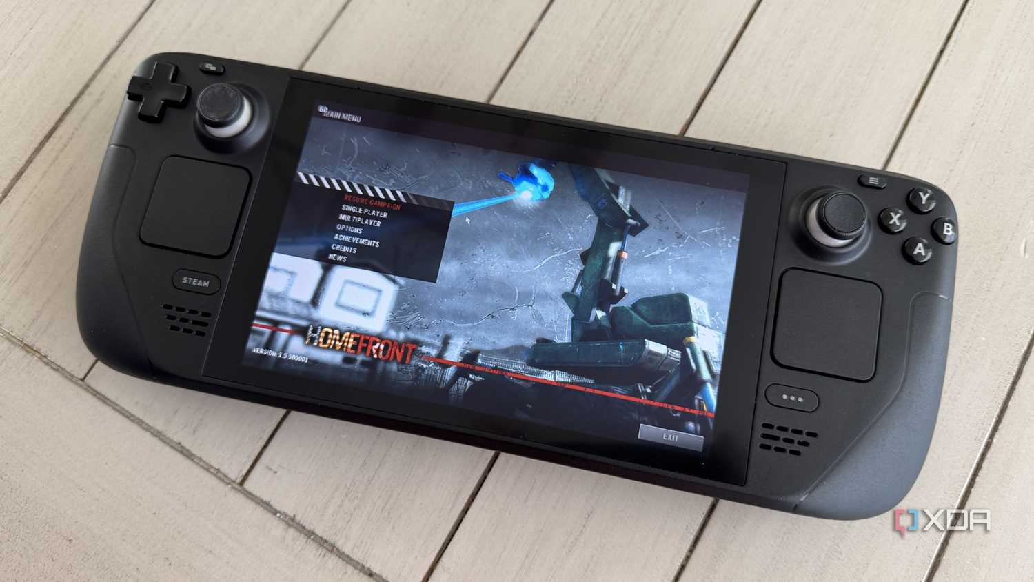 steam deck on table with the game homefront running