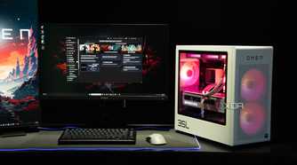 A white Omen-brand gaming PC on a dark desk with black peripherals
