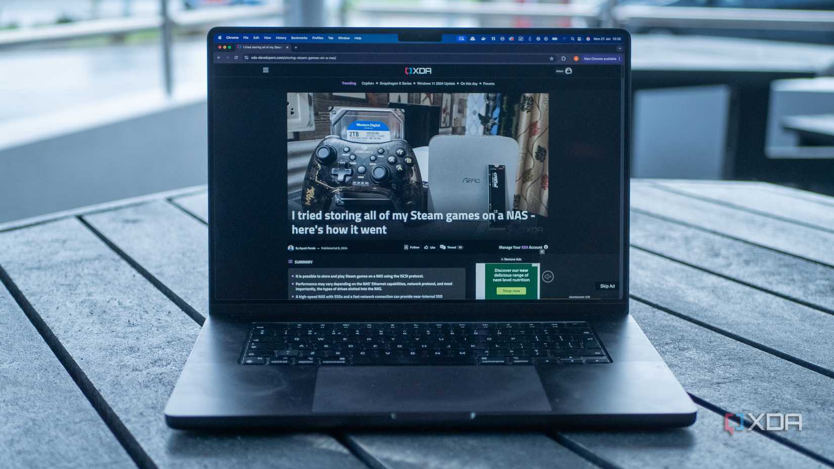 A 16-inch MacBook Pro showing the XDA home page