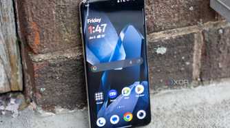 A OnePlus 13 standing up against a wall