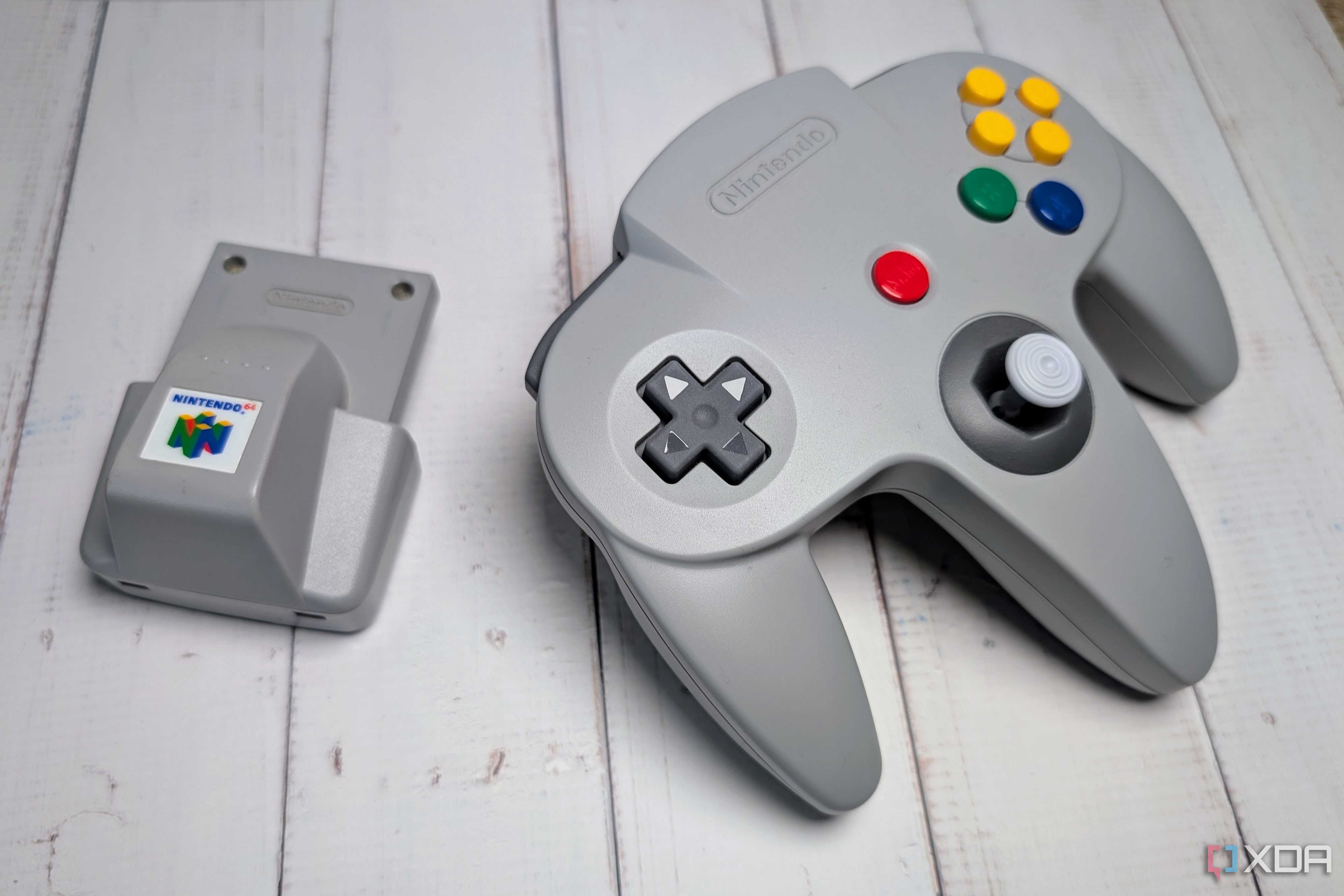 Rumble pak beside a Nintendo 64 controller