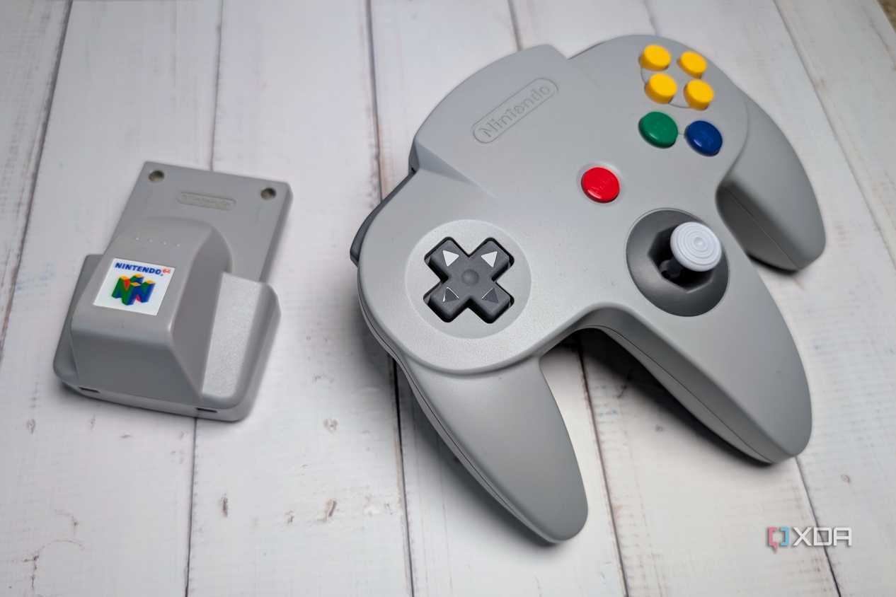 Rumble pak beside a Nintendo 64 controller