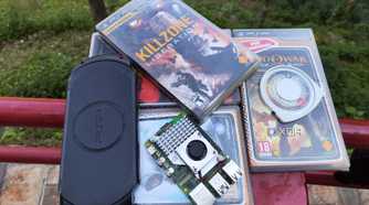 A Raspberry Pi placed near a PSP and some UMDs