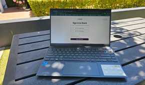 a laptop outside on a table showing a slack login screen