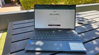 a laptop outside on a table showing a slack login screen