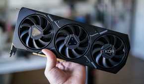 A hand holding AMD's RX 7900 XT graphics card.