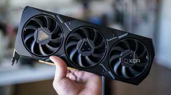 A hand holding AMD's RX 7900 XT graphics card.