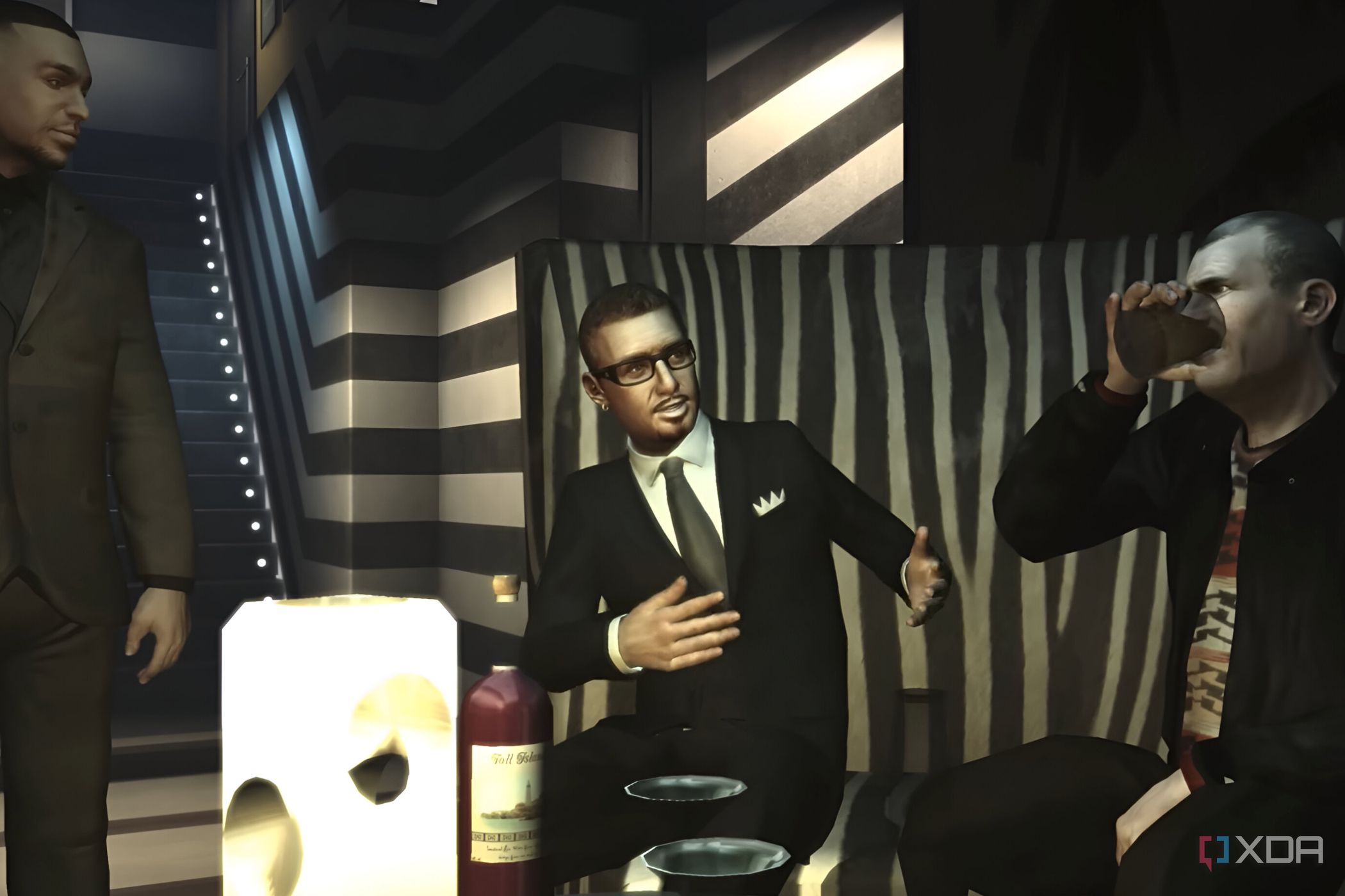 A screenshot from GTA IV: The Ballad of Gay Tony, showing three characters in suits conversing in a club.