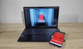 a laptop with netflix and a smartphone with unified remote