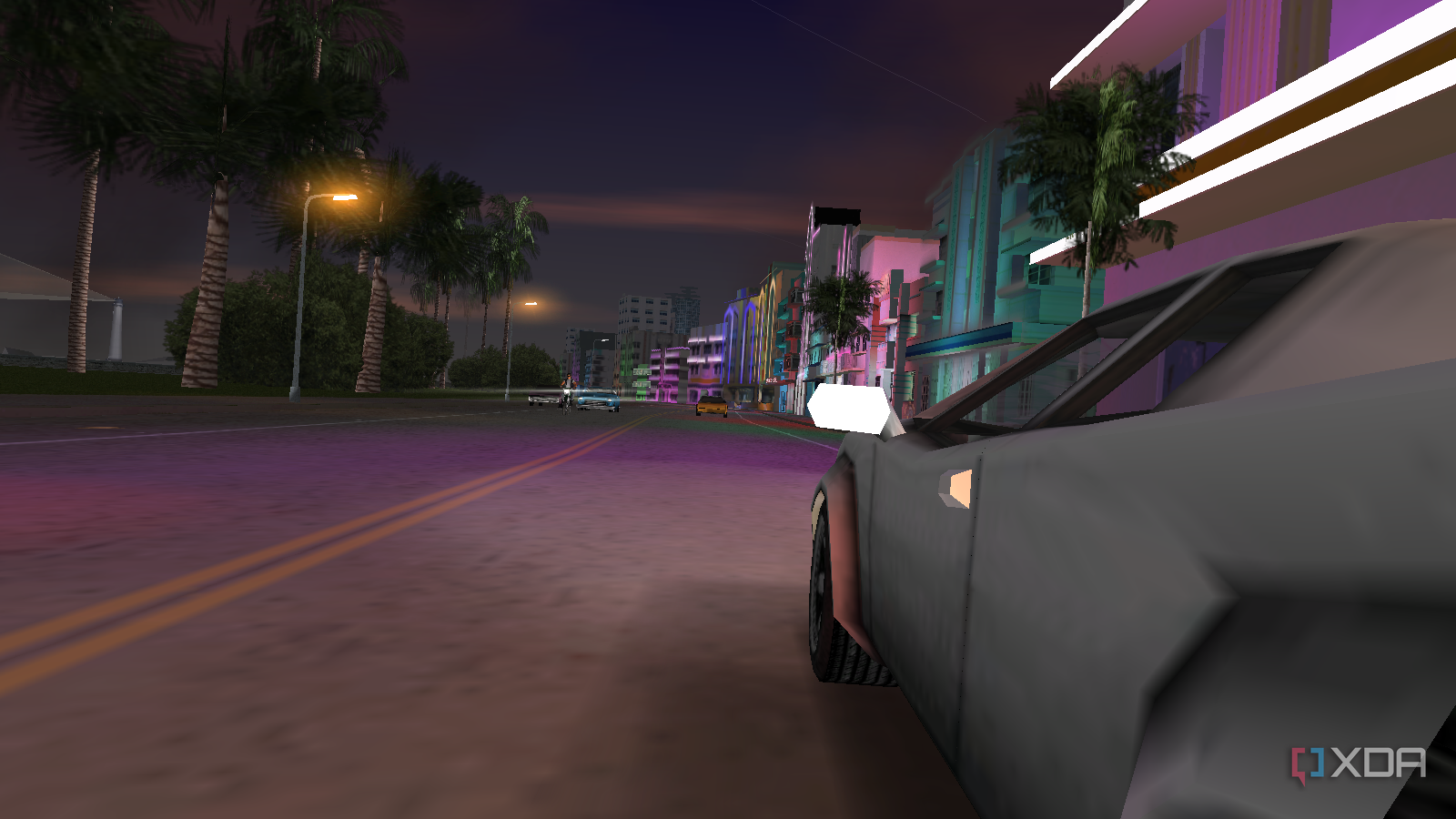 Side view of a white car being driven in the ocean drive street in Vice City