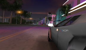 Side view of a white car being driven in the ocean drive street in Vice City