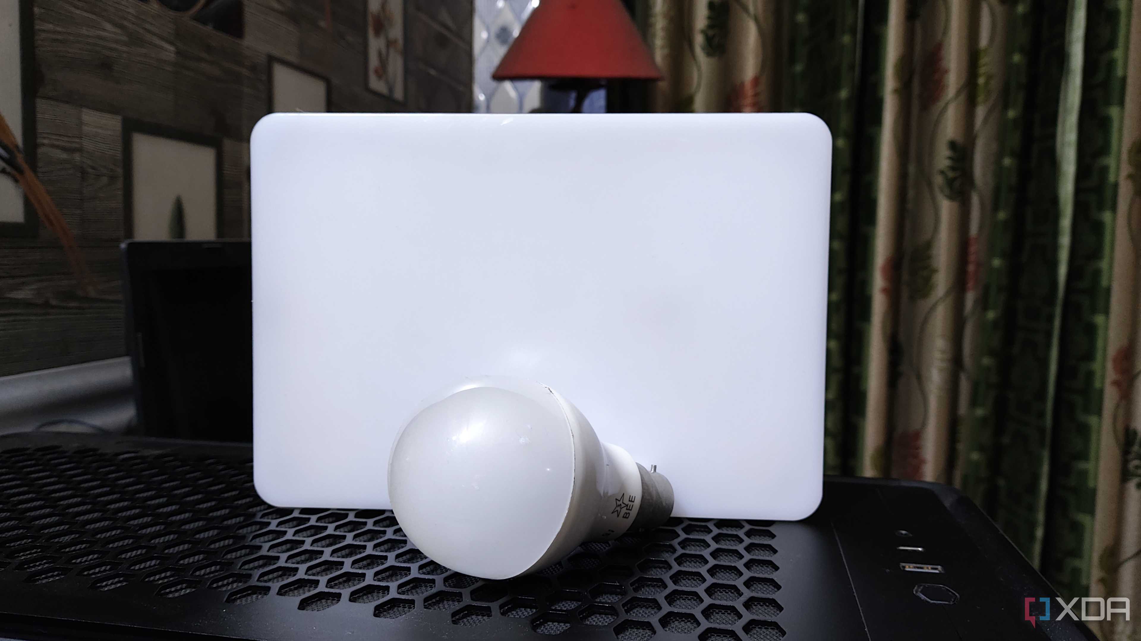 A bulb and an LED resting on top of a PC case