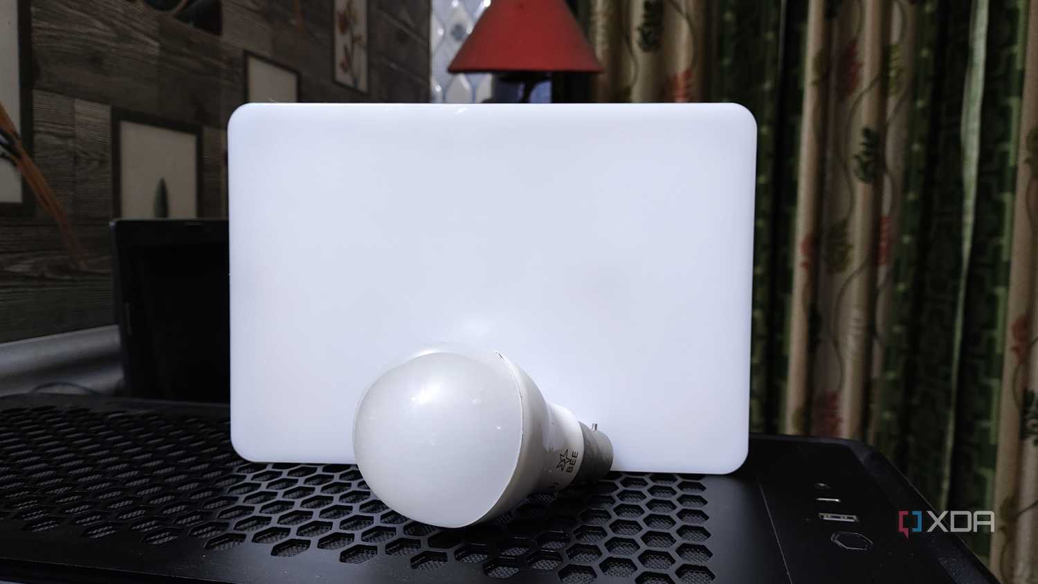 A bulb and an LED resting on top of a PC case