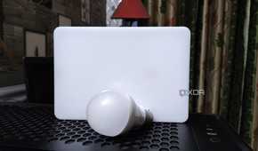 A bulb and an LED resting on top of a PC case