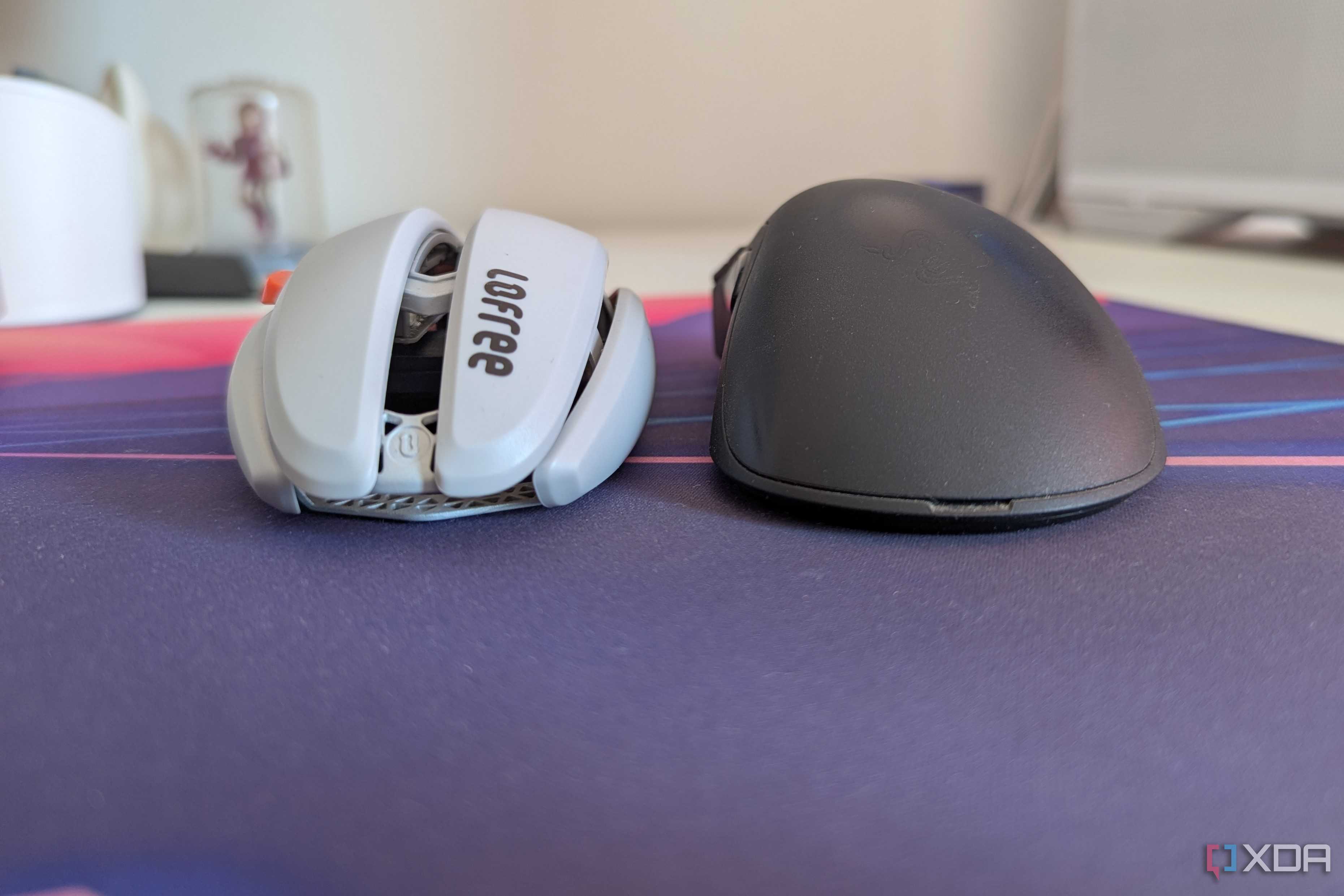 A white and black gaming mouse side by side