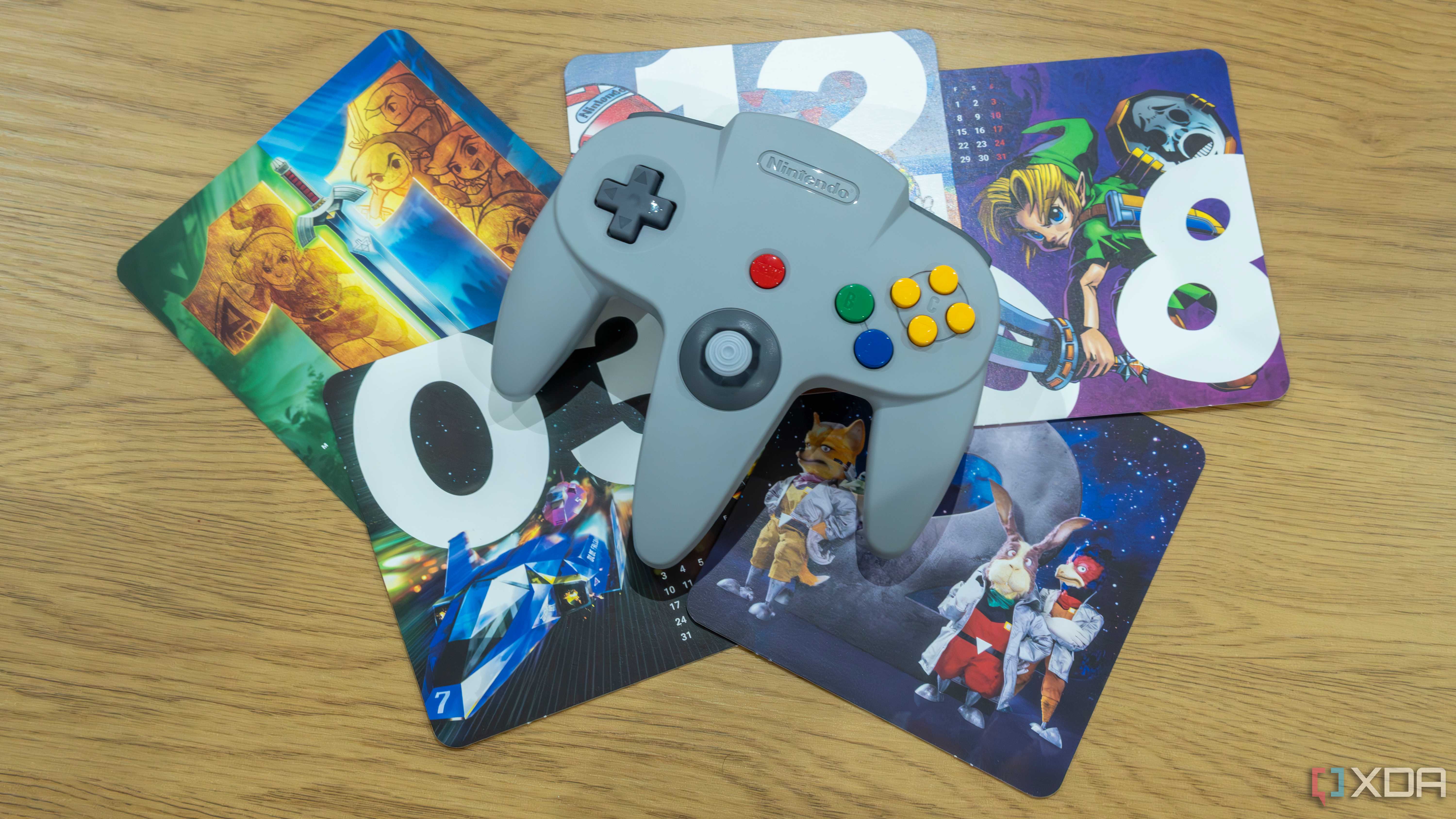 Overhead view of the Nintendo 64 controller with images of various Nintendo 64 games in the background