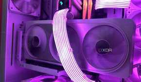 A vertical white Nvidia RTX 4070 Ti inside an all-white cabinet, with purple-lit Lian Li Strimer cables running across it.