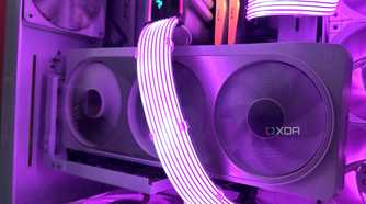 A vertical white Nvidia RTX 4070 Ti inside an all-white cabinet, with purple-lit Lian Li Strimer cables running across it.