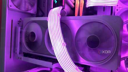 Inside the all-white cabinet is a vertical white Nvidia RTX 4070 Ti with purple-lit Lian Li Streamer cables running through it.