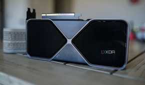 The RTX 5070 graphics card sitting on a table with the fans facing outward.