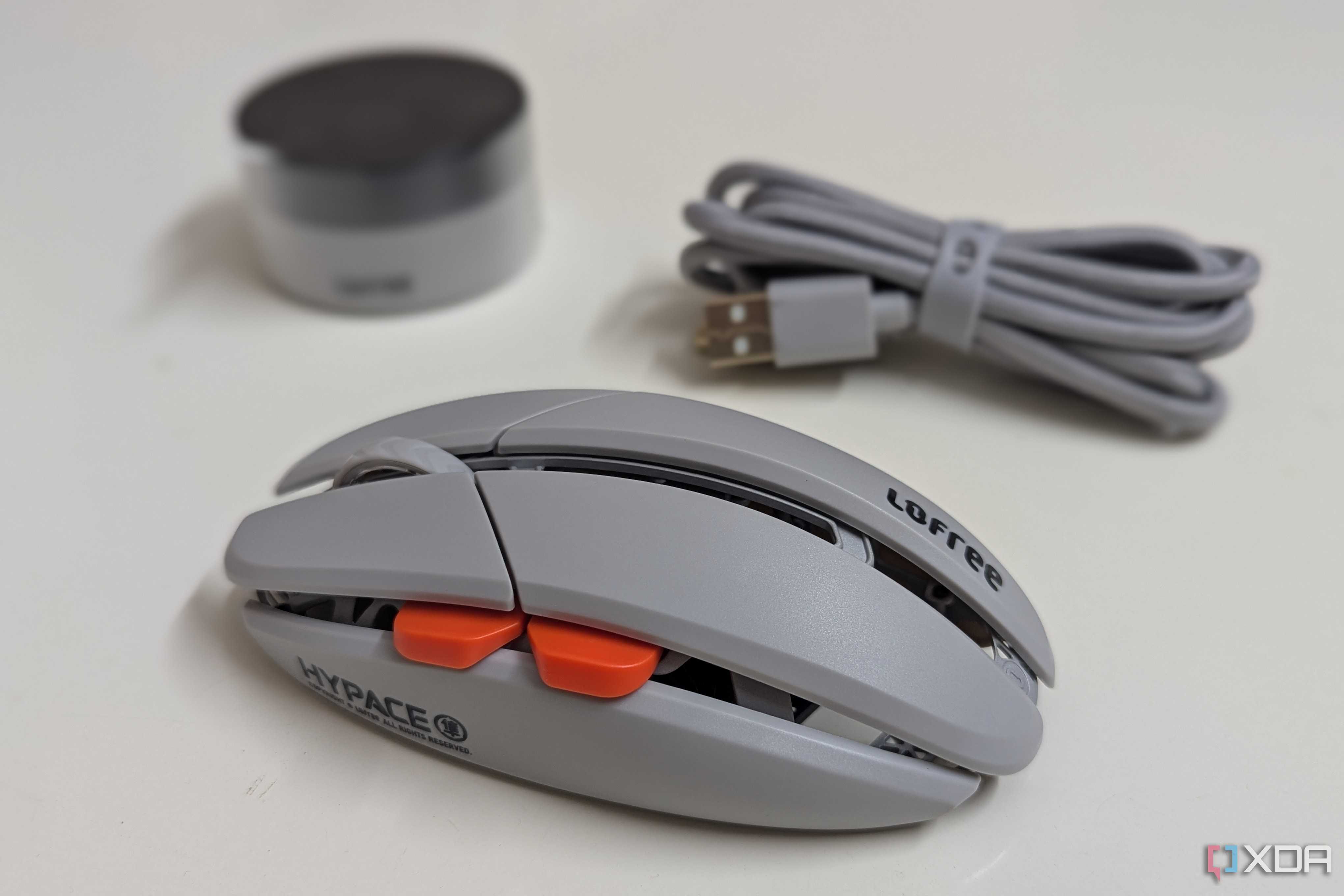 Side view of a gaming mouse with a wireless dongle and USB cable