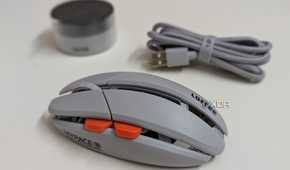 Side view of a gaming mouse with a wireless dongle and USB cable