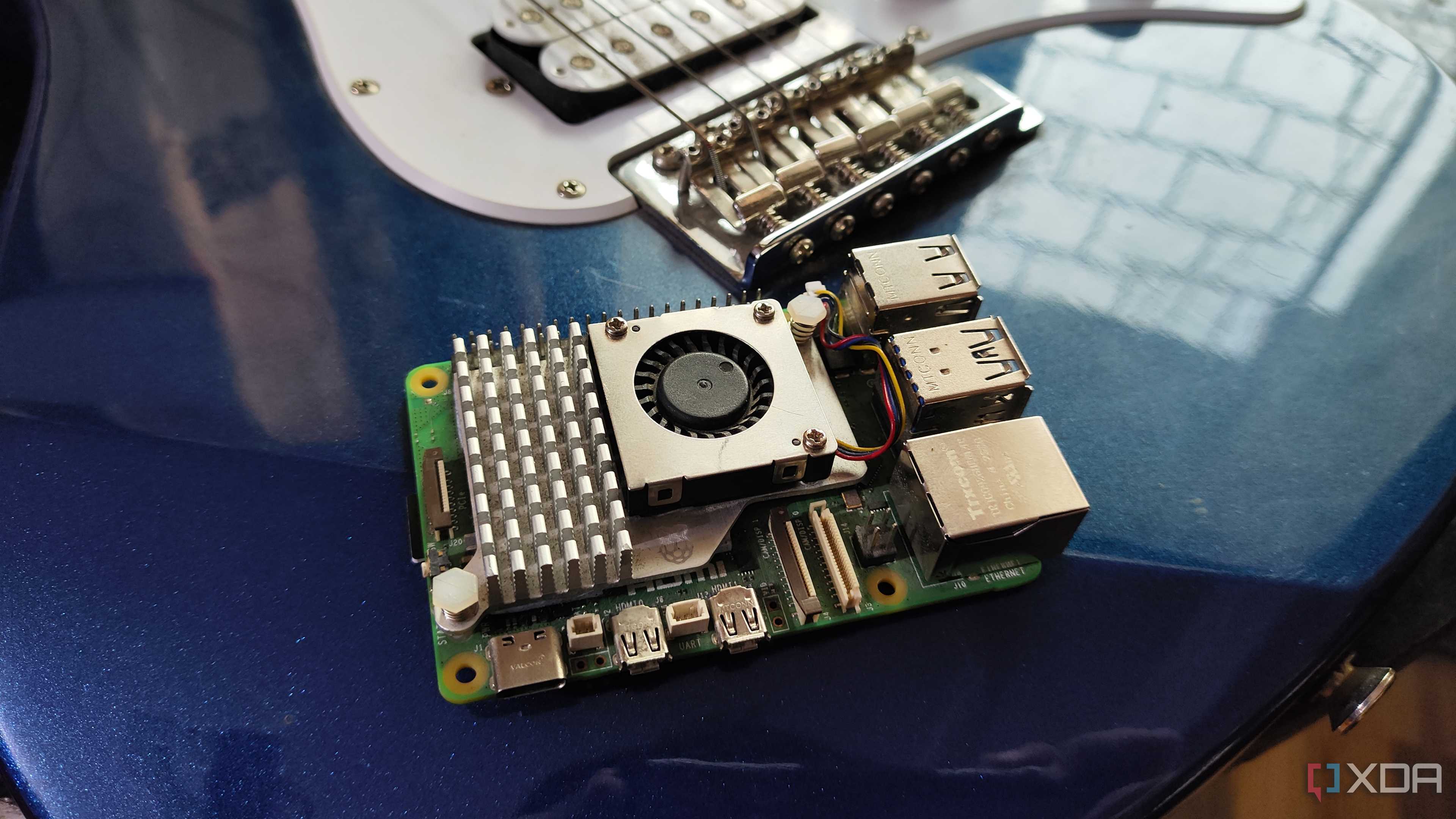 A Raspberry Pi 5 resting against a Yamaha Pacifica 012