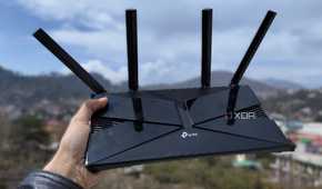 A person holding a TP-Link router